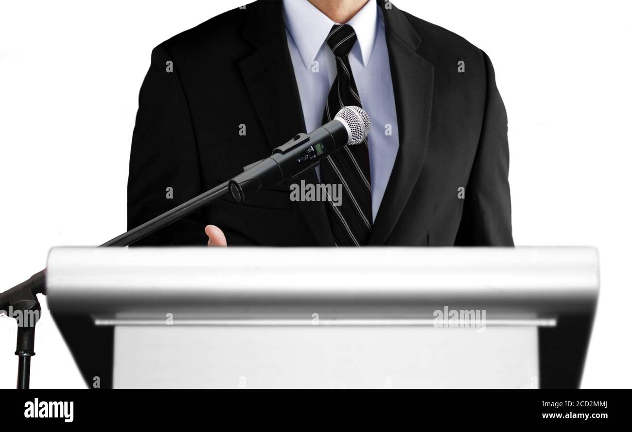 man giving speech using microphone on stage Stock Photo