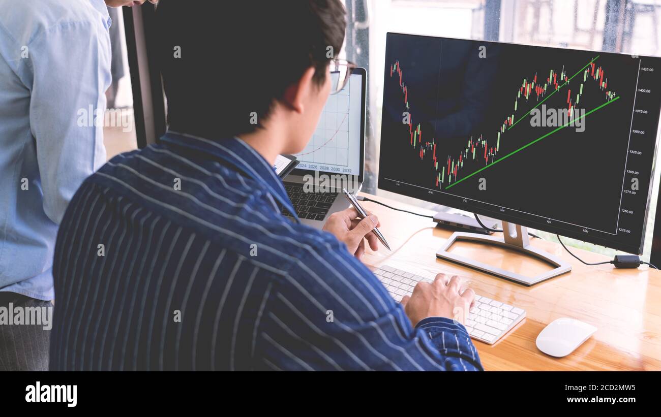 broker showing some ascending to his colleague planning and analyzing ...