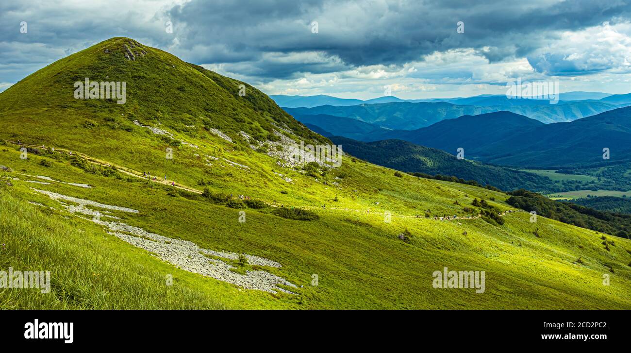 Mountain landscape in Bieszczady Poland. Blue sky and white clouds over meadow in the mountains. Stock Photo