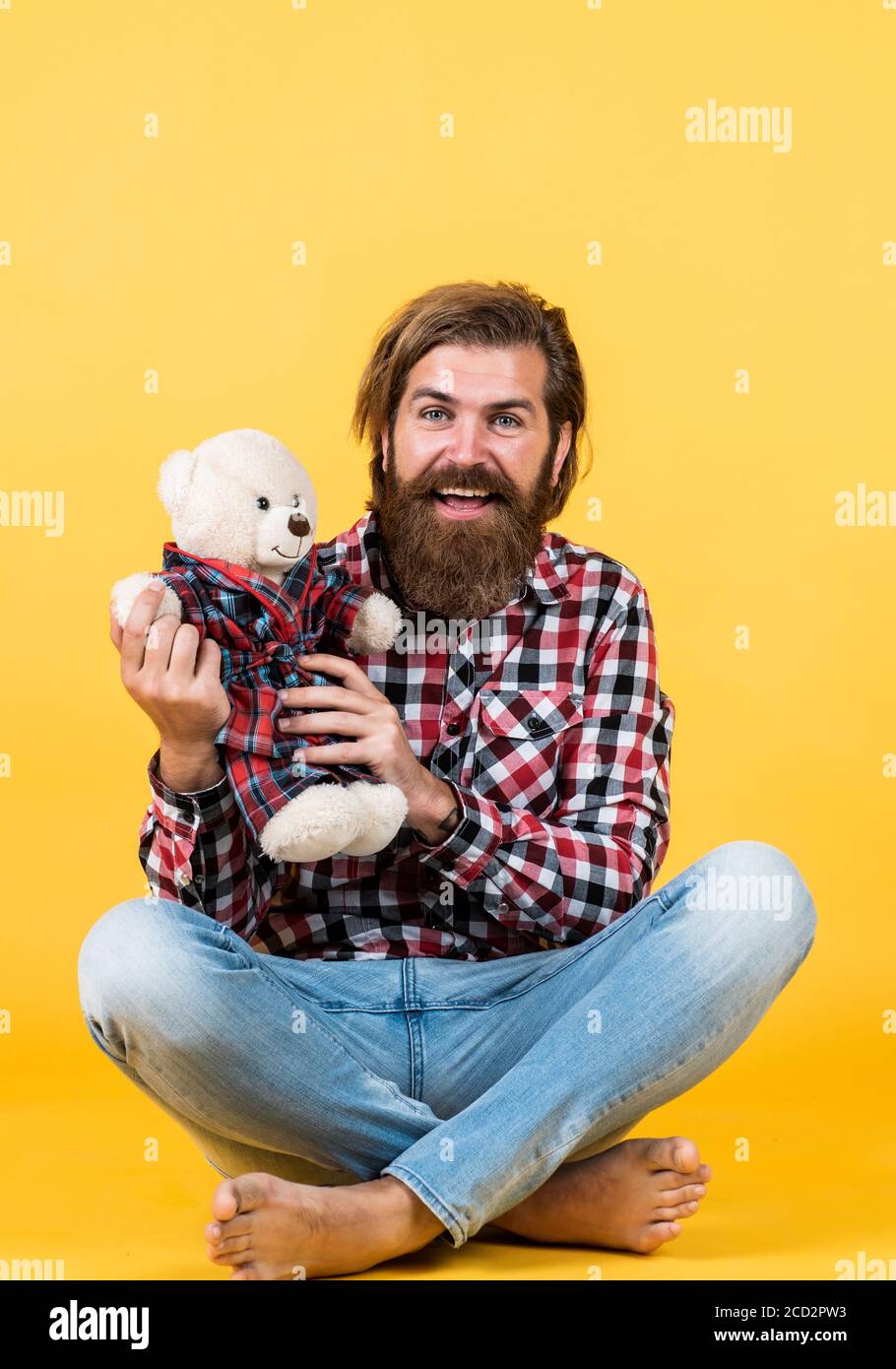 best present ever. Valentines day gift for beloved. Holiday celebration concept. Guy with happy face plays with soft toy. Childish mood concept. guy enjoy valentines day. Holiday celebration. Stock Photo