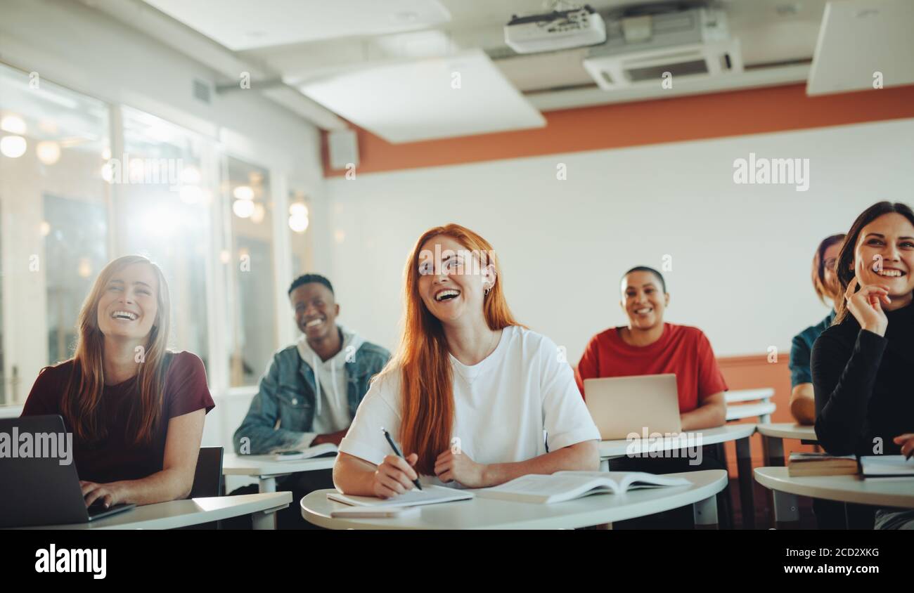 Group Of Teenage Students Smiling During The Lecture In Classroom ...