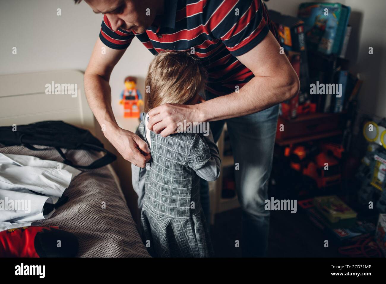 Father helping daughter dressing uniform preparation back to school