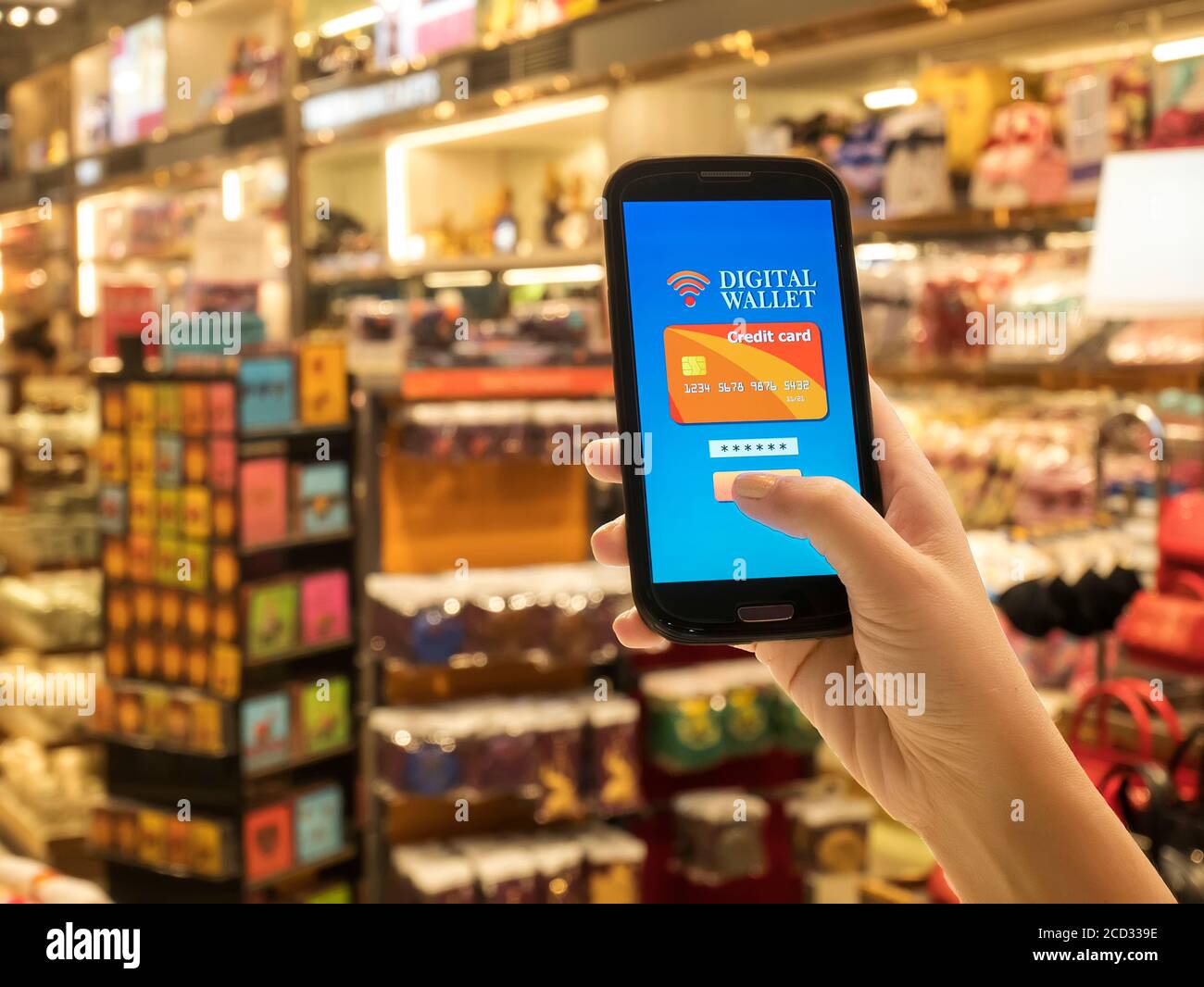 Mobile wallet concept on smart phone screen over blur store background, e-commerce, smart pay, business and technology concept Stock Photo