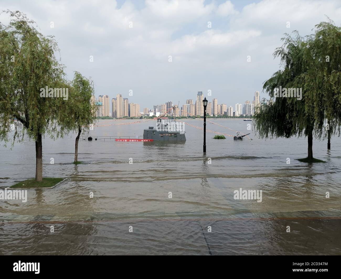 A patrol boat is flooded by rising water level caused by rainstorm in Wuhan city, south China's Hubei province, 30 June 2020. Stock Photo