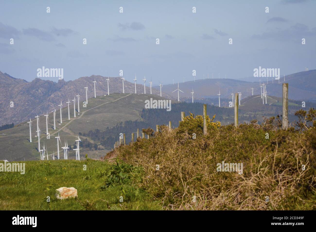 Landscape with lined up wind turbines of a wind farm on a mountain rig ...