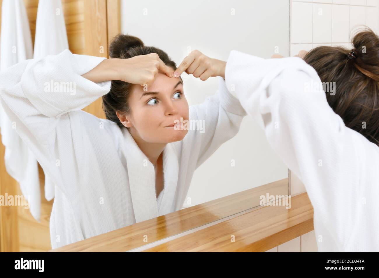 Woman squeeze pimples in the bathroom Stock Photo Alamy