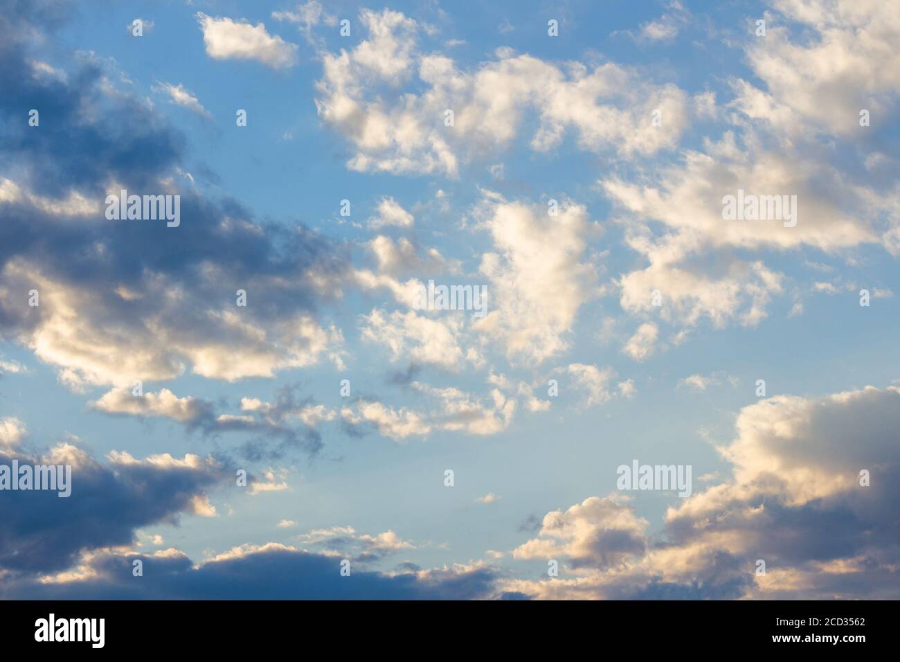 cloudy sky in yellow light. natural background at sunrise. inspiring scene Stock Photo