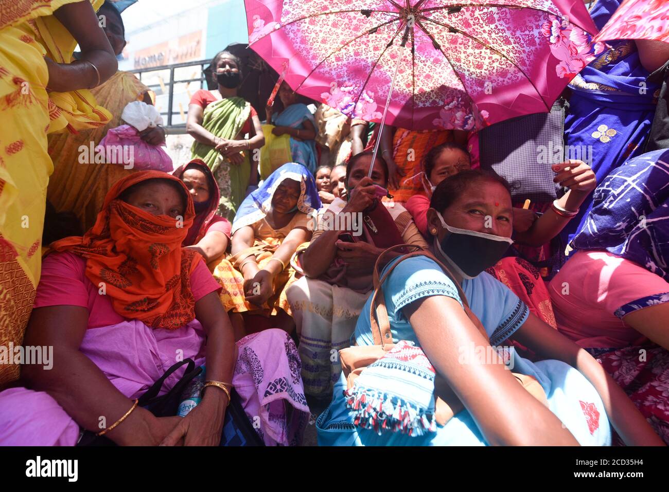 Guwahati, Assam, India. 25th Aug, 2020. People flout social distancing norms as they stand in a queue to register for Aadhar cards, amid the ongoing COVID-19 coronavirus pandemic, in Guwahati. Credit: David Talukdar/ZUMA Wire/Alamy Live News Stock Photo