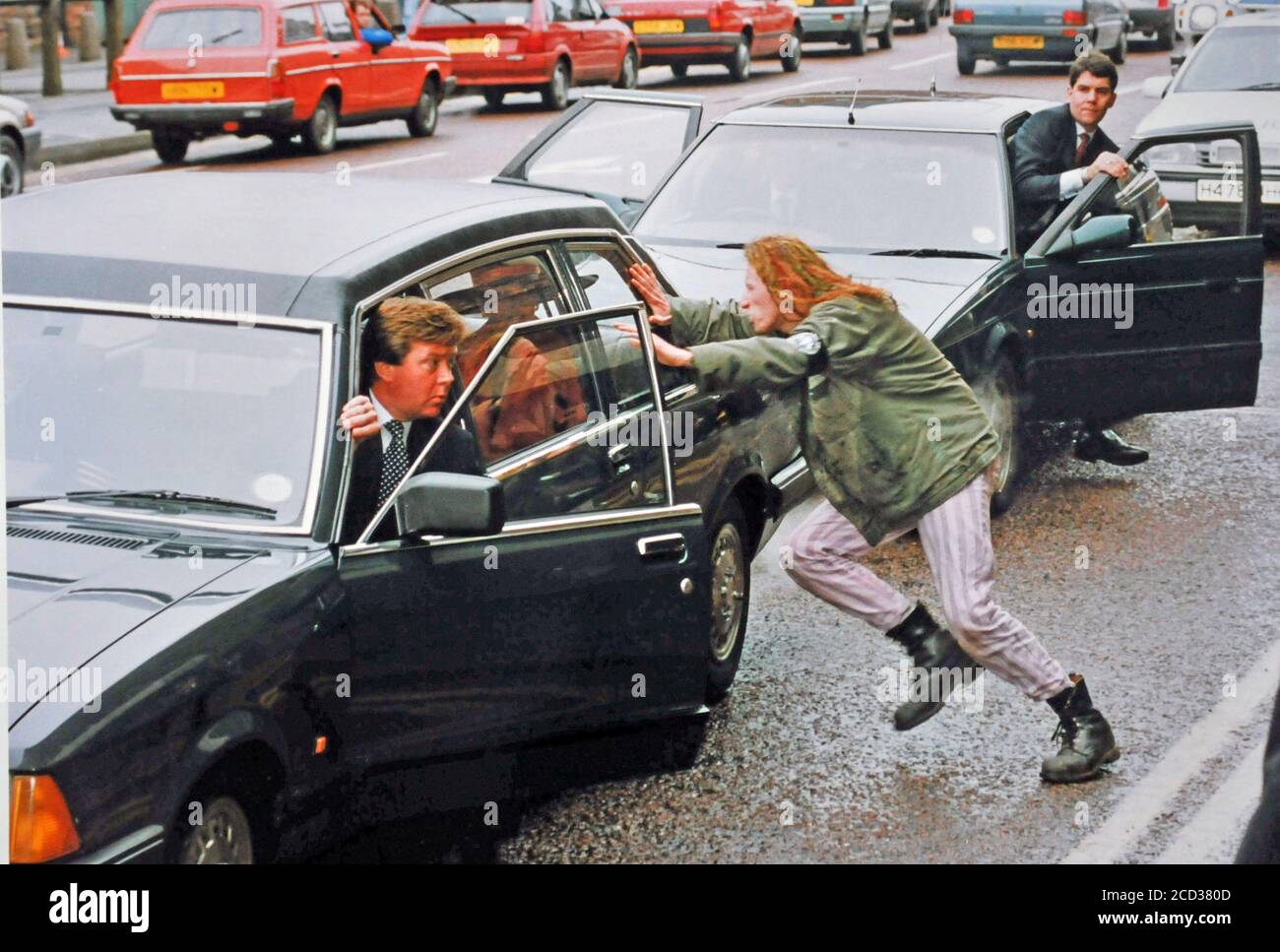 April 30th 1992 / Peter Callaghan, a CND supporter attacks the car that Diana Princess of Wales is in the back off. The attack happened when the Princess was arriving at the Barrow shipyard in Cumbria, UK. to launch Britain's first nuclear submarine HMS Vanguard.Diana's security guard Ken Wharf gets out of the car to protect her. Callaghan was later charged with an offence.....Pic by RAY BRADBURY Stock Photo