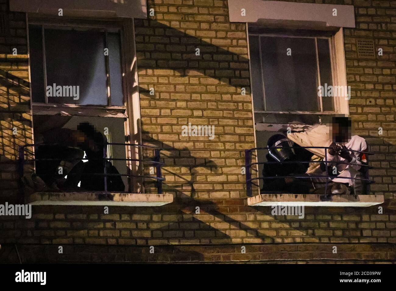 FACES PIXELATED BY PA PICTURE DESK Occupants attempt to escape the premises as Metropolitan Police officers raid a property on York Way in London, as they target the 'elders' or 'high ups' in a north London criminal gang. Stock Photo