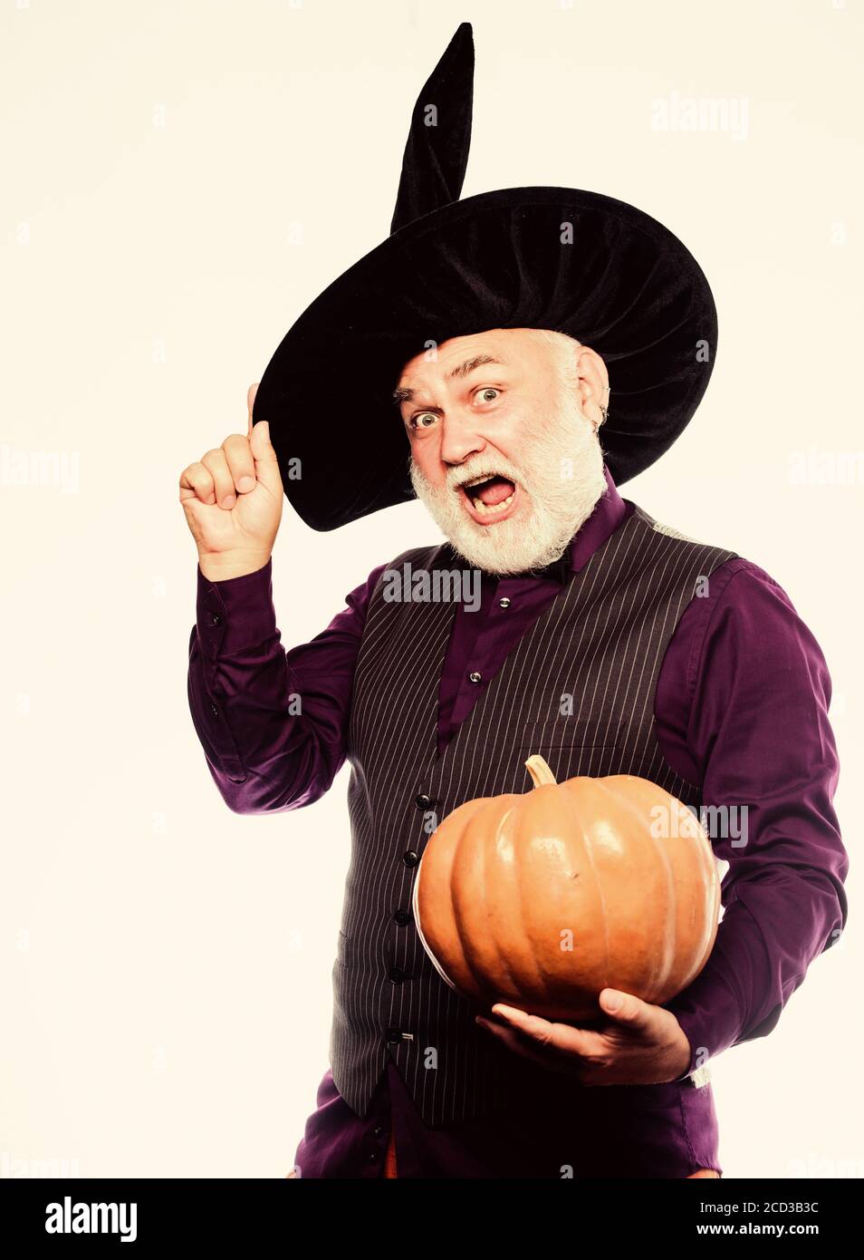 Cosplay outfit. Senior man white beard celebrate Halloween with pumpkin. Wizard costume hat Halloween party. Magician witcher old man. Magic concept. Experienced and wise. Halloween tradition. Stock Photo