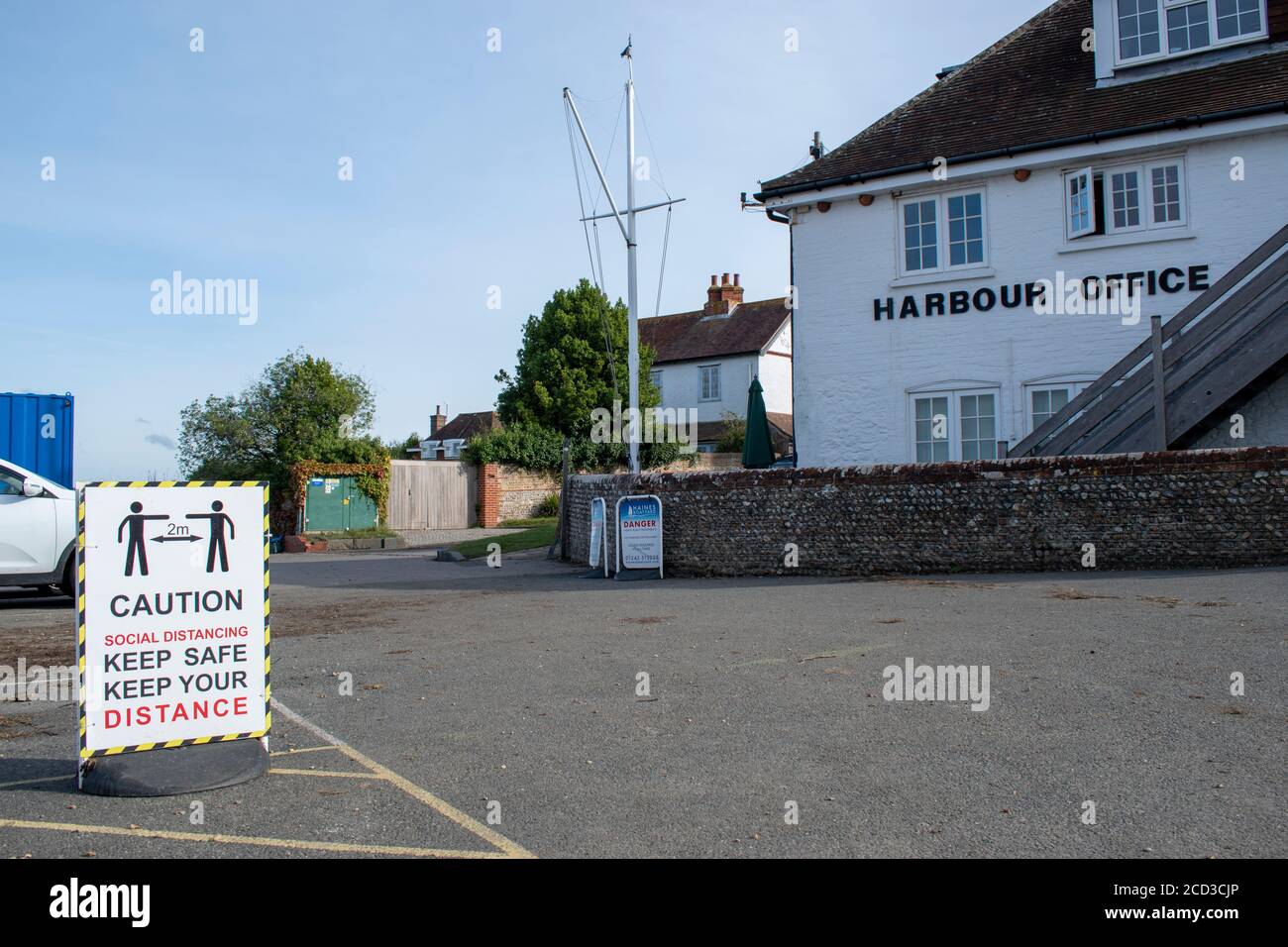 Social Distancing Sign at the popular recreational boating location of Itchenor in West Sussex. Stock Photo