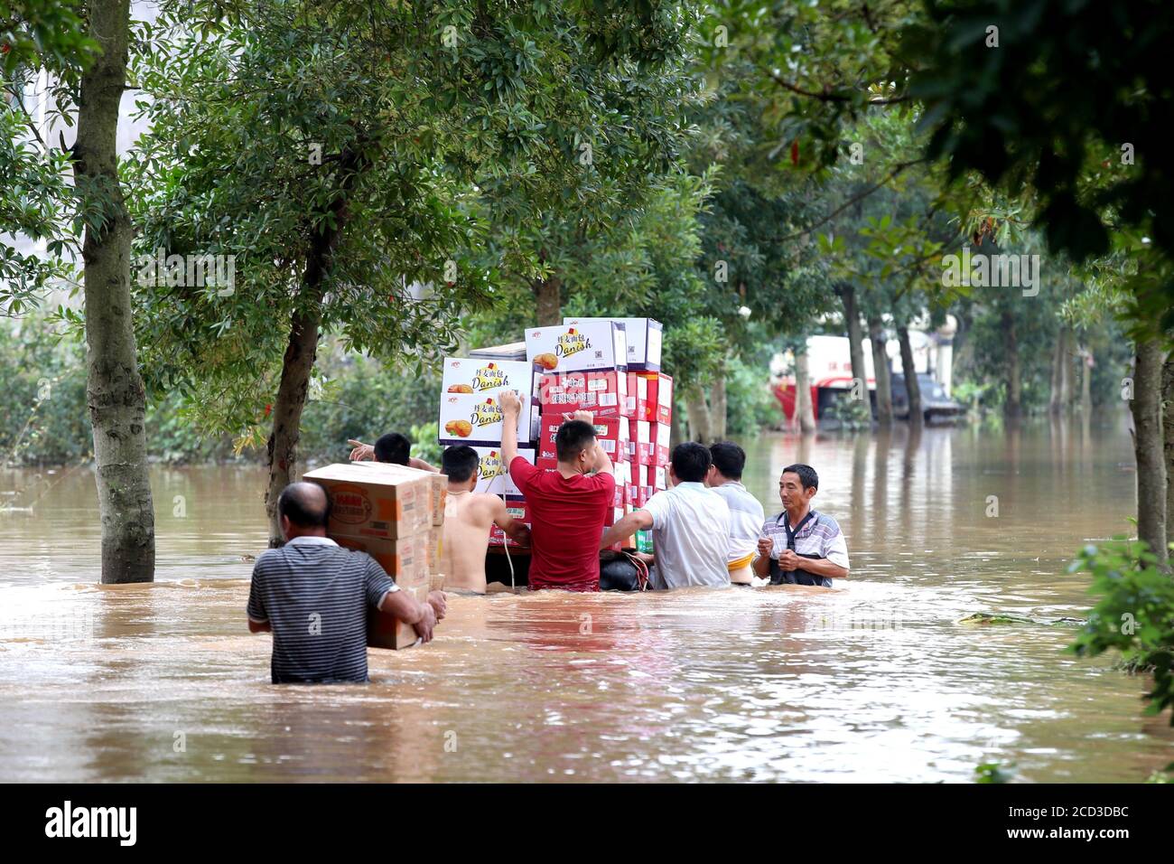 A rescue team transports relief supplies in the flood caused by heavy rainfall in Ji'an city, east China's Jiangxi province, 10 July 2020. Stock Photo