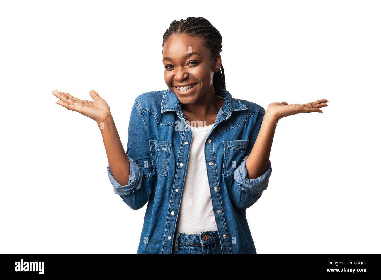 Cheerful African American Girl Shrugging Shoulders Posing Standing In Studio Stock Photo