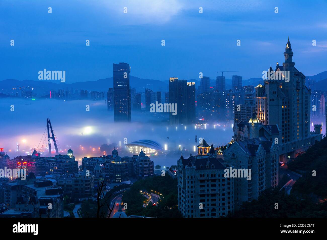An aerial view of buildings, bridges and the Xinghai Bay covered by 