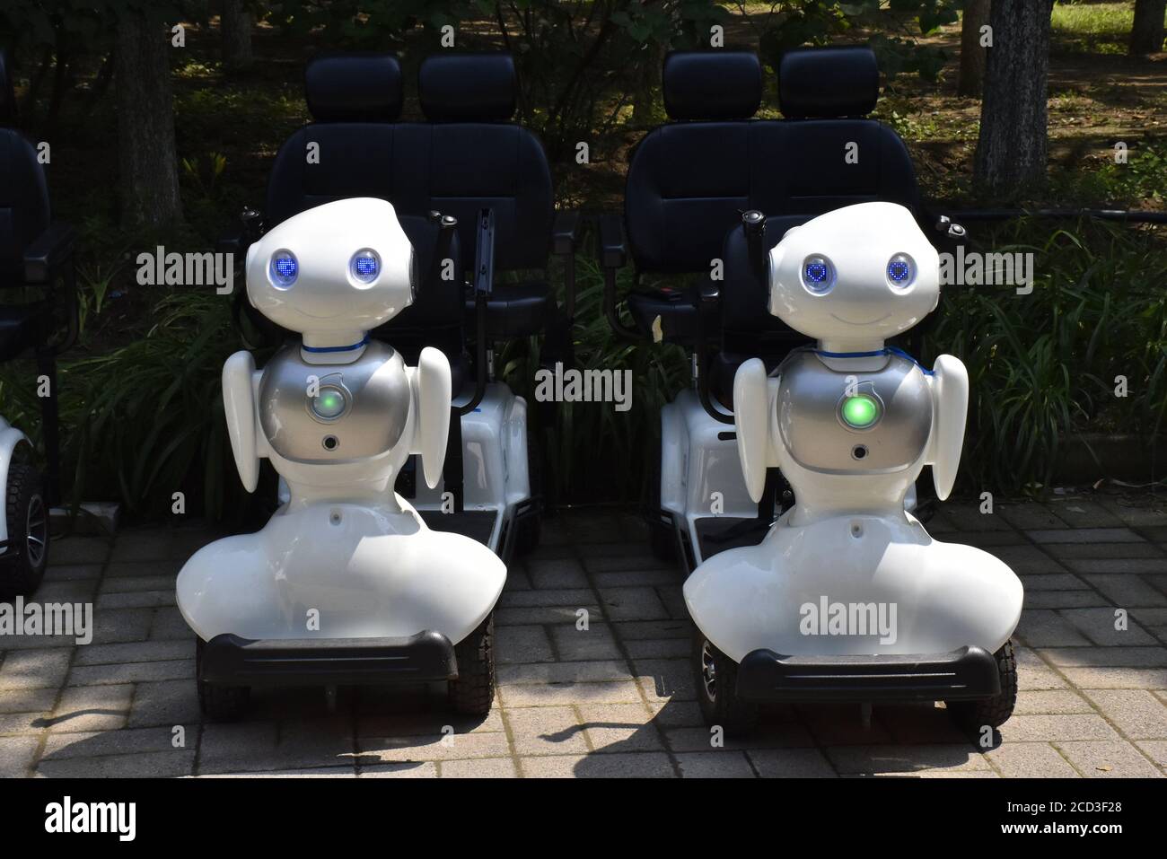 People ride on the robots designed for tour guide at the Olympic Forest Park in Beijing, China, 5 July 2020. Stock Photo