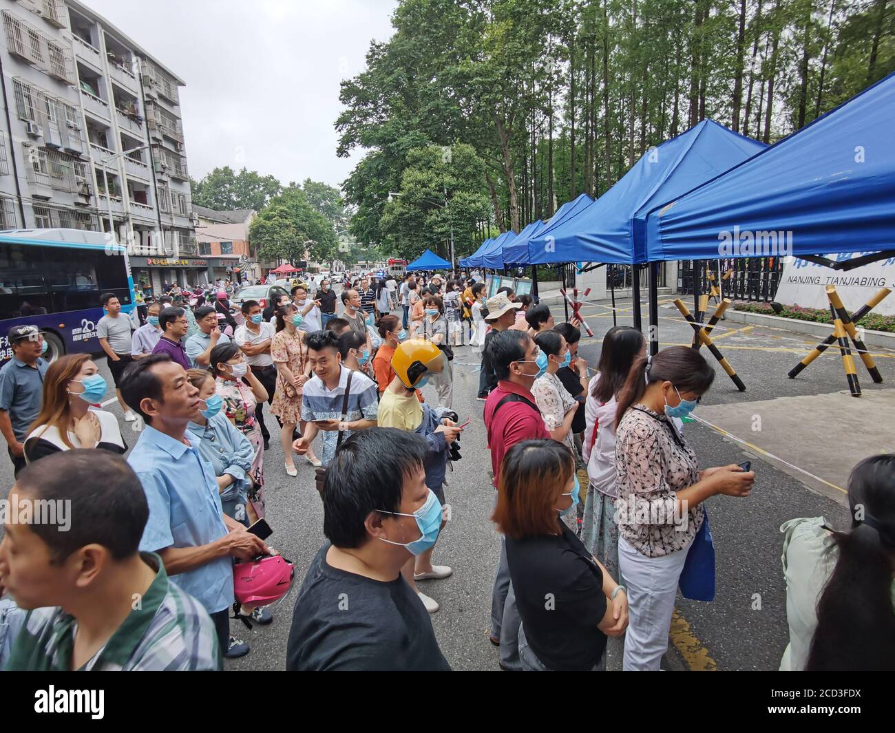 Parents wait outside the testing center for their children in the last day of the 2020 National College Entrance, also known as Gaokao, Nanjing city, Stock Photo