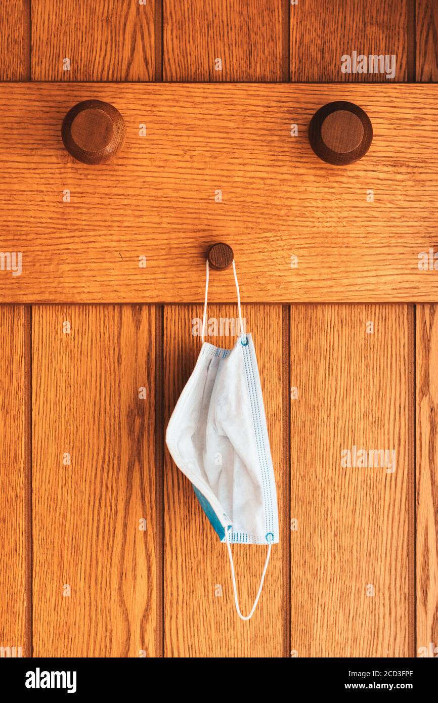 Protective surgical face mask on anteroom coat hanger stand during
