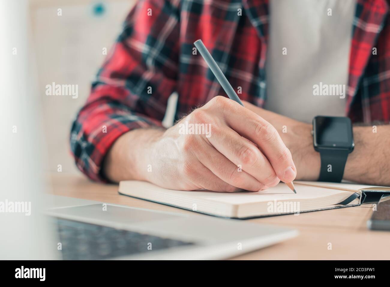 Freelancer writing notes in notebook, selective focus Stock Photo