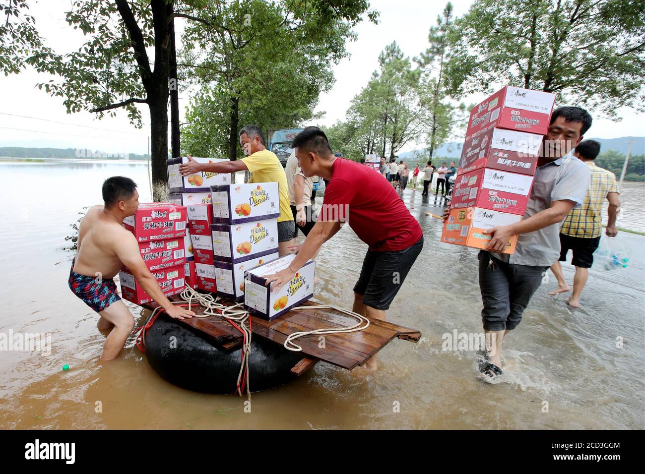 A rescue team transports relief supplies in the flood caused by heavy rainfall in Ji'an city, east China's Jiangxi province, 10 July 2020. Stock Photo