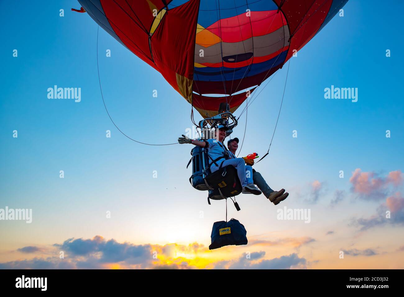Tandem hot air balloon A man and woman sit on a seat Stock Photo