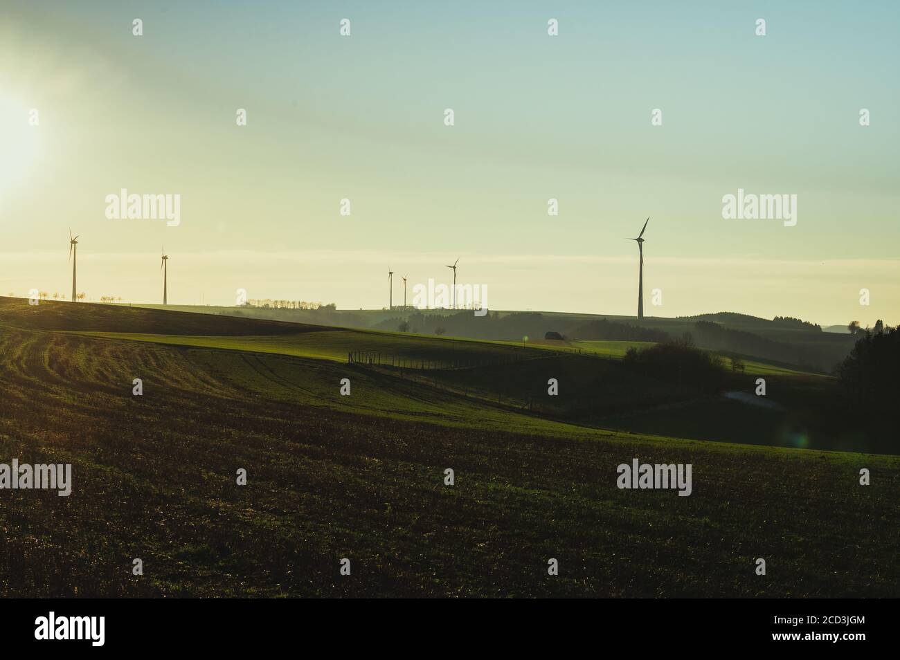 wind turbines in green field at sunset Stock Photo - Alamy