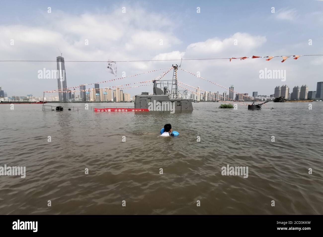 A patrol boat is flooded by rising water level caused by rainstorm in Wuhan city, south China's Hubei province, 30 June 2020. Stock Photo