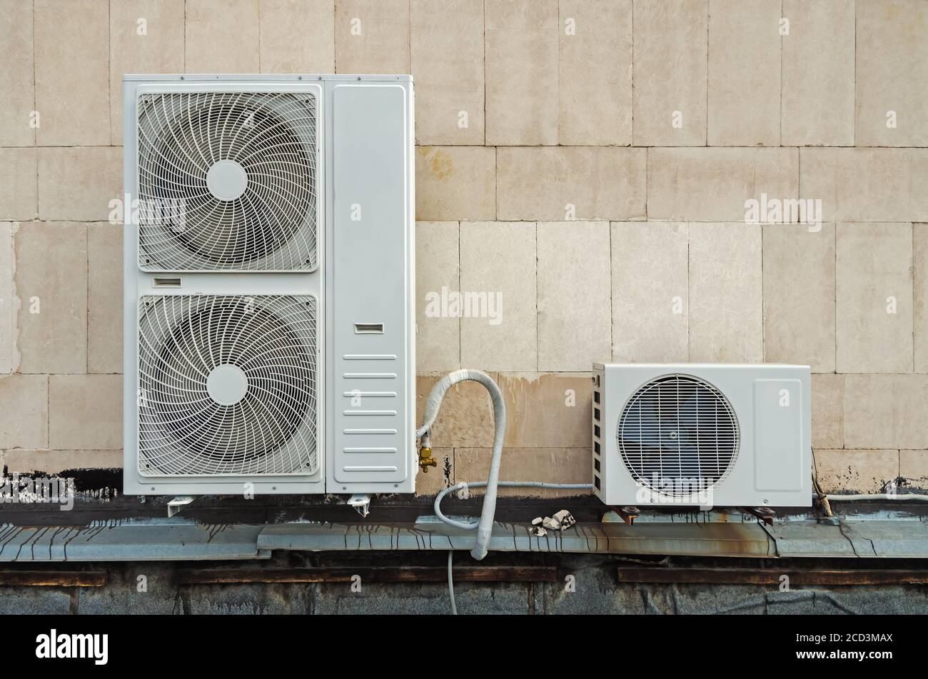 Functioning air compressor and air condenser unit located on flat roof