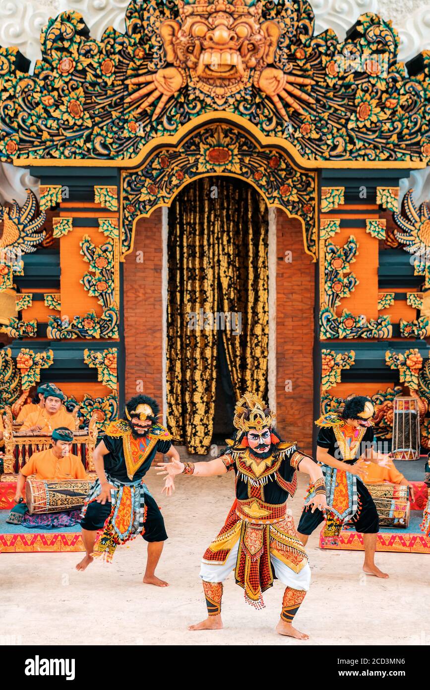 09.01.2020, Bali, Indonesia. Three men in theatrical costumes dance a traditional dance. Vertical. Galungan Holiday. Stock Photo