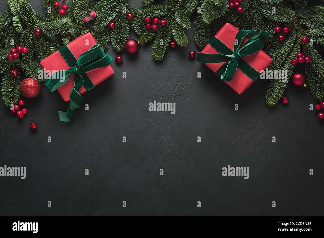 Christmas frame with red gifts, fir branches on black background. Xmas ...