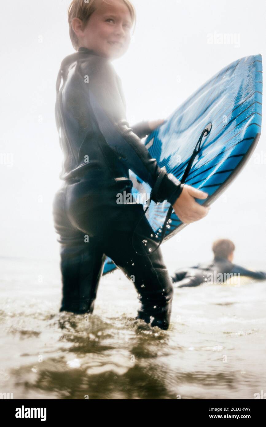 Boy surfing teen wetsuit hi res stock photography and images Alamy