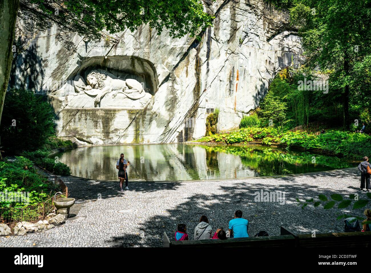 Lucerne Switzerland , 29 June 2020 : Wide angle view of Lion monument and pool with tourists around it in Lucerne Switzerland Stock Photo