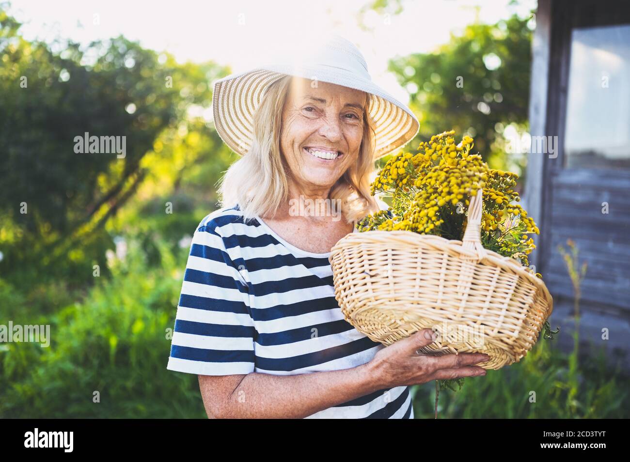 Happy smiling elderly senior woman in straw hat having fun posing in ...