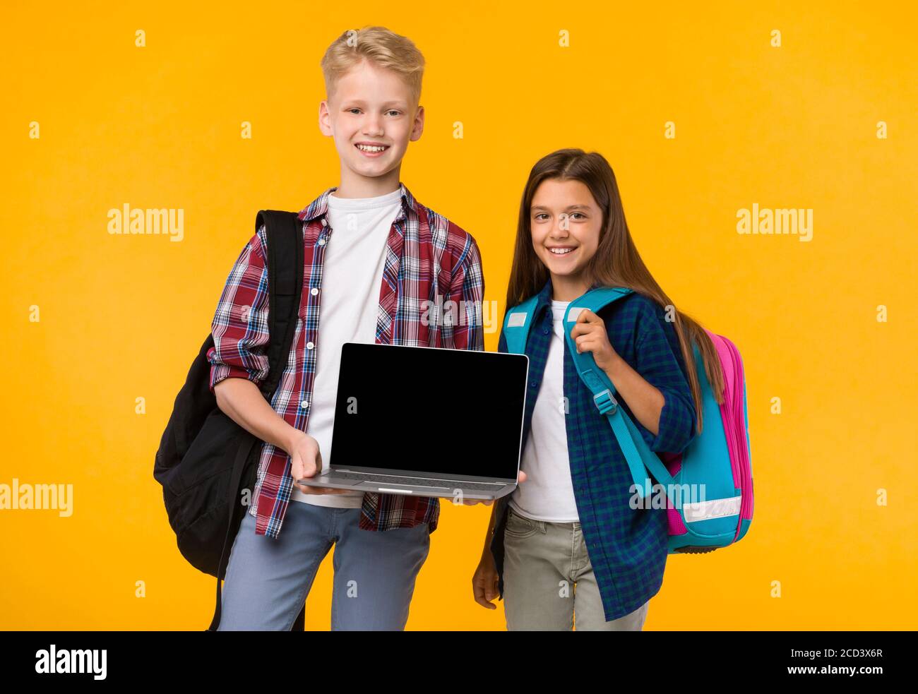 School boy and girl showing laptop screen at camera Stock Photo - Alamy