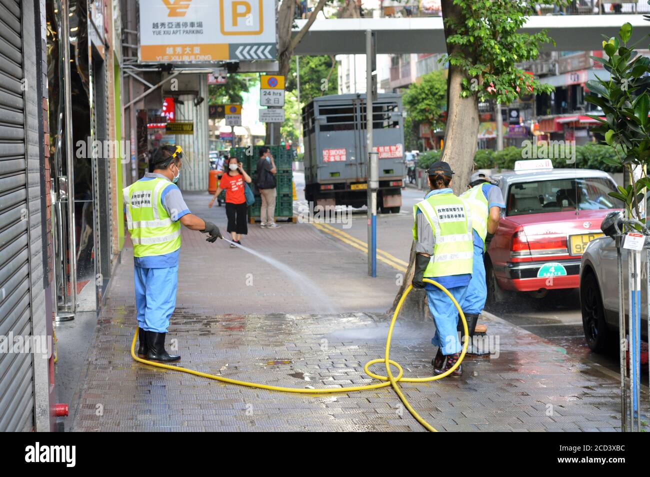 Workers of the Food and Environmental Hygiene Department (FEHD) clean a