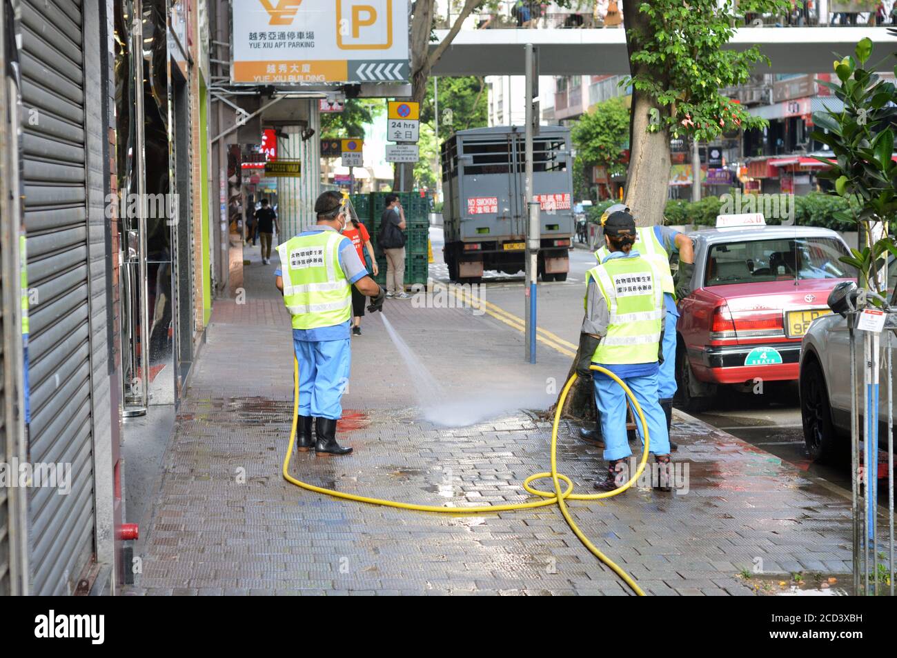 Workers of the Food and Environmental Hygiene Department (FEHD) clean a