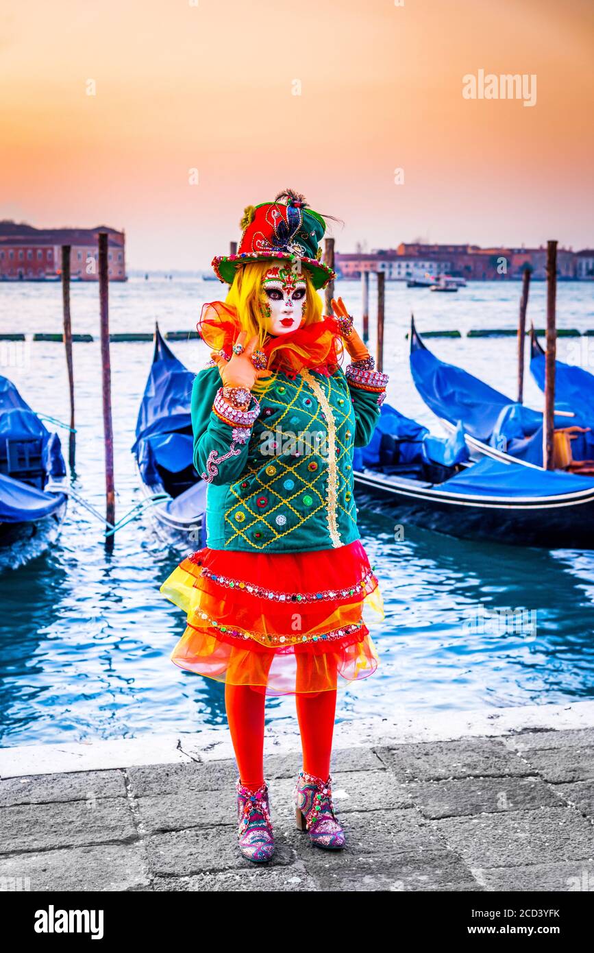 Venice, Italy, venetian masked model from the Venice Carnival, with Gondolas in the background, Grand Canal Stock Photo