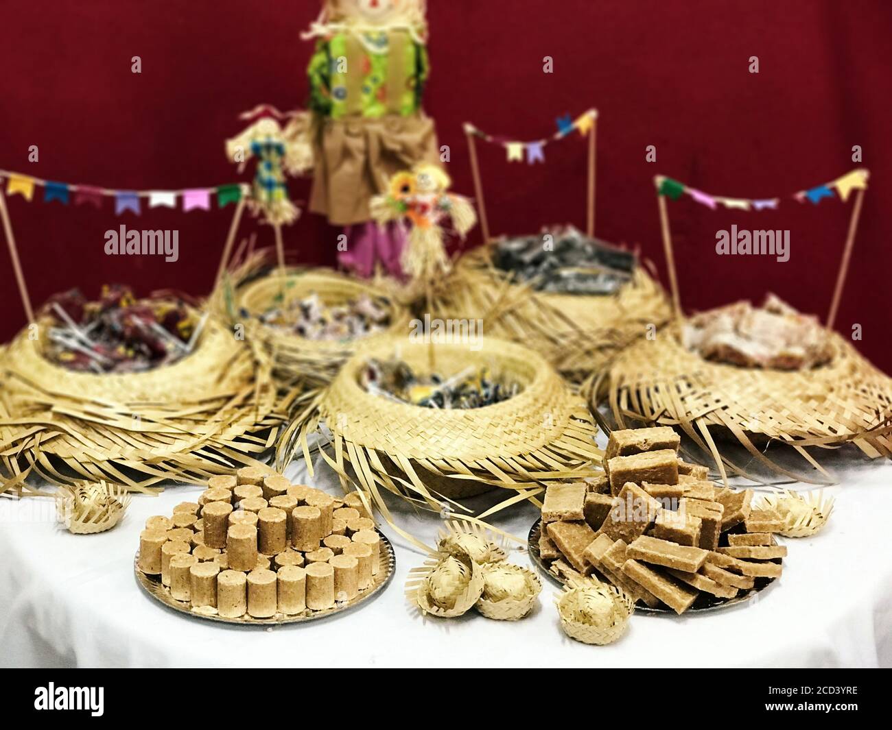 Table of typical food of junina party: paçoca candy, lollipops, cake, dulce de leche, peanut candy. Stock Photo