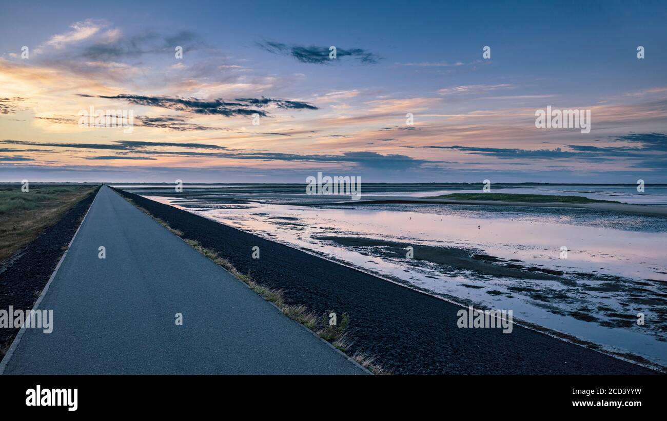 Bike path at sunset through the island landscape Stock Photo