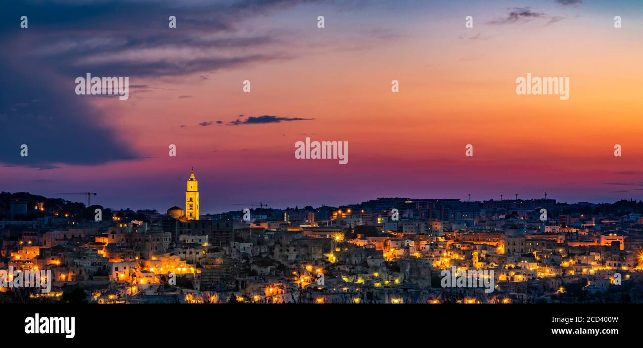 The spectacular fiery sunset and the panorama of the Sassi di Matera in Basilicata, Italy. The top view of the city from the park of the Rupestrian Ch Stock Photo