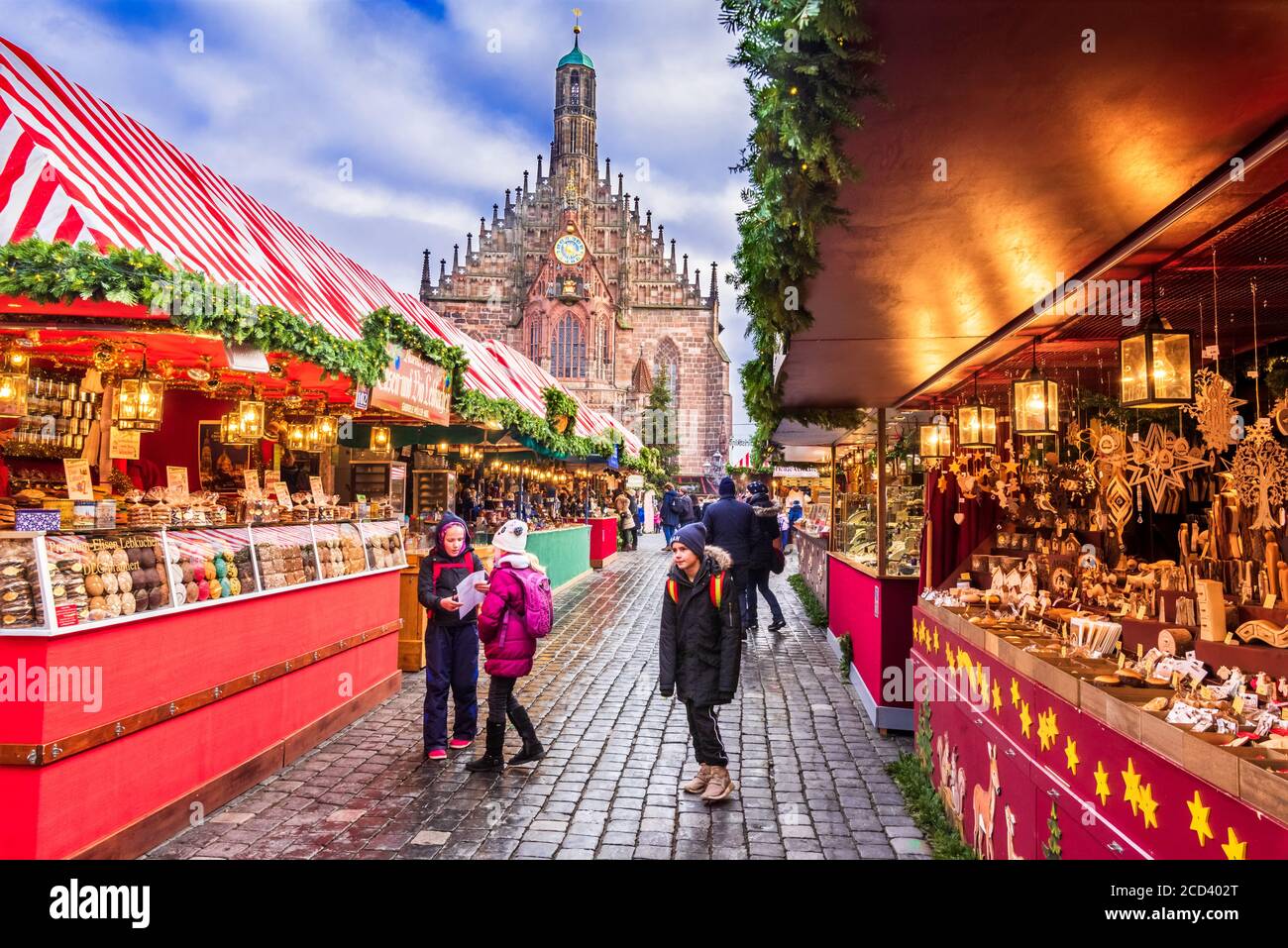 Nuremnerg, Germany - December 2018: People explore Christmas market on Nuremberg's Christkindlesmarkt one of Germany's oldest Christmas markets dating Stock Photo