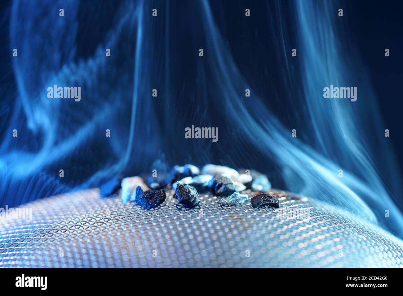 Closeup shot of styrax resin with blue flame Stock Photo