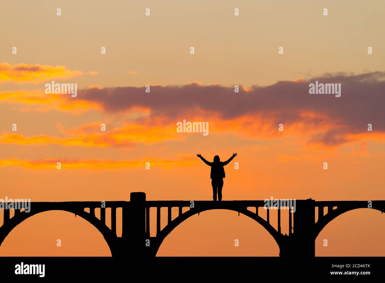 Silhouette of a woman on old bridge Stock Photo - Alamy