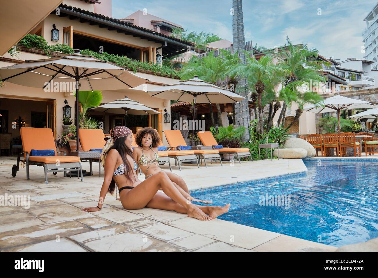 Young women enjoying swimming pool at vacation Villa, Puerto Vallarta, Jalisco, Mexico Stock Photo