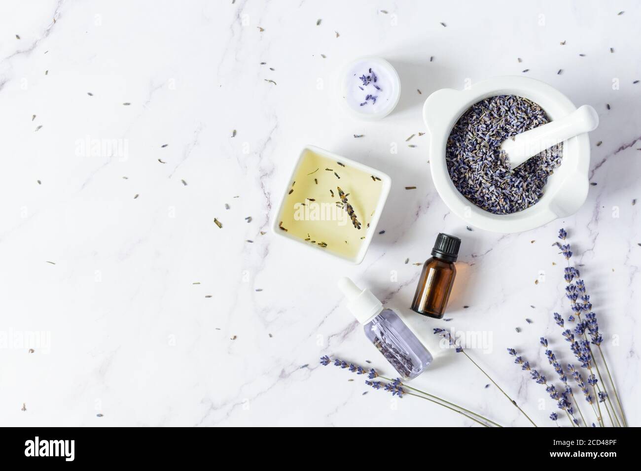 Aromatic essential and massage oil with lavender flowers on white ...