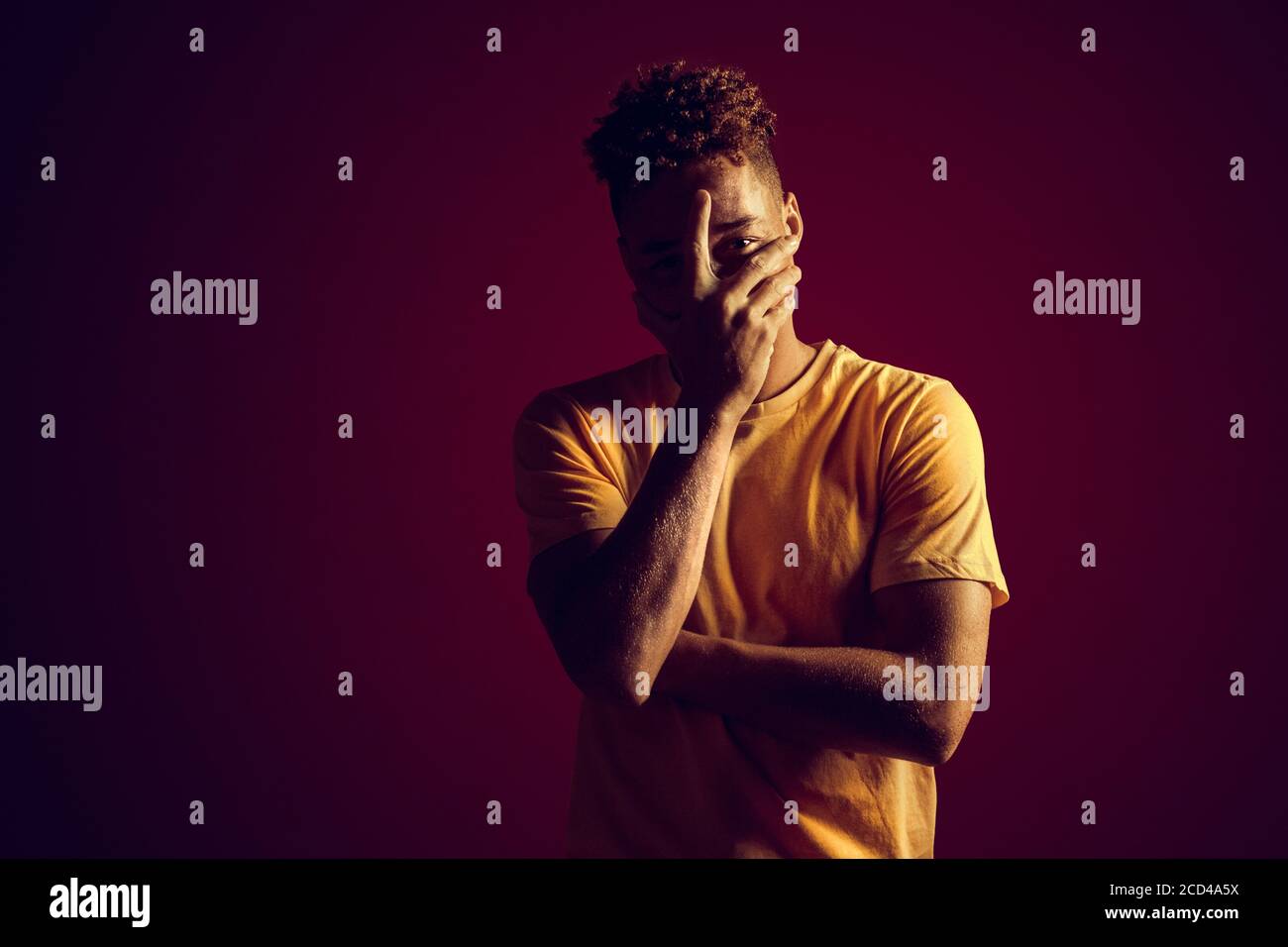Young adult man cover face with palm hand Stock Photo - Alamy