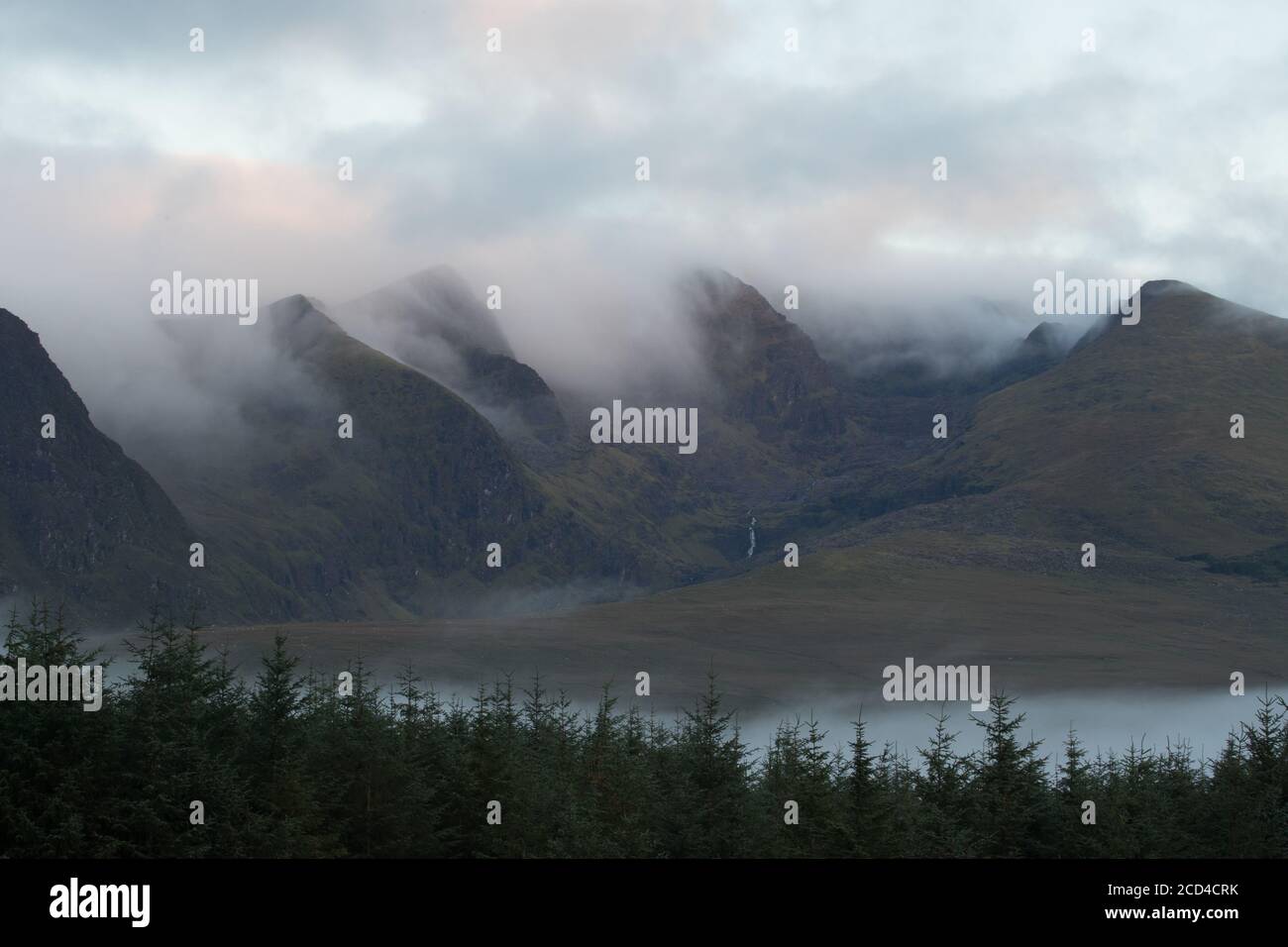 Dramatic clouds and morning mist moving over scenic landscape on the dingle peninsula at dawn, wild Atlantic way in county Kerry, Ireland Stock Photo