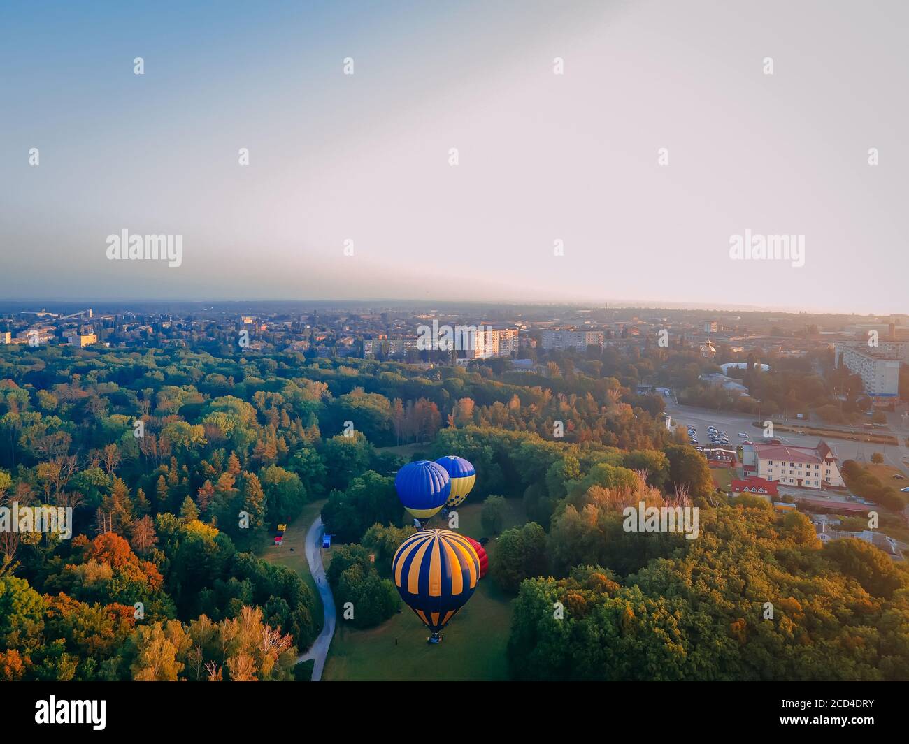 Hot air ballons prepare for an early morning takeoff from park in small european city, Kiev region, Ukraine Stock Photo