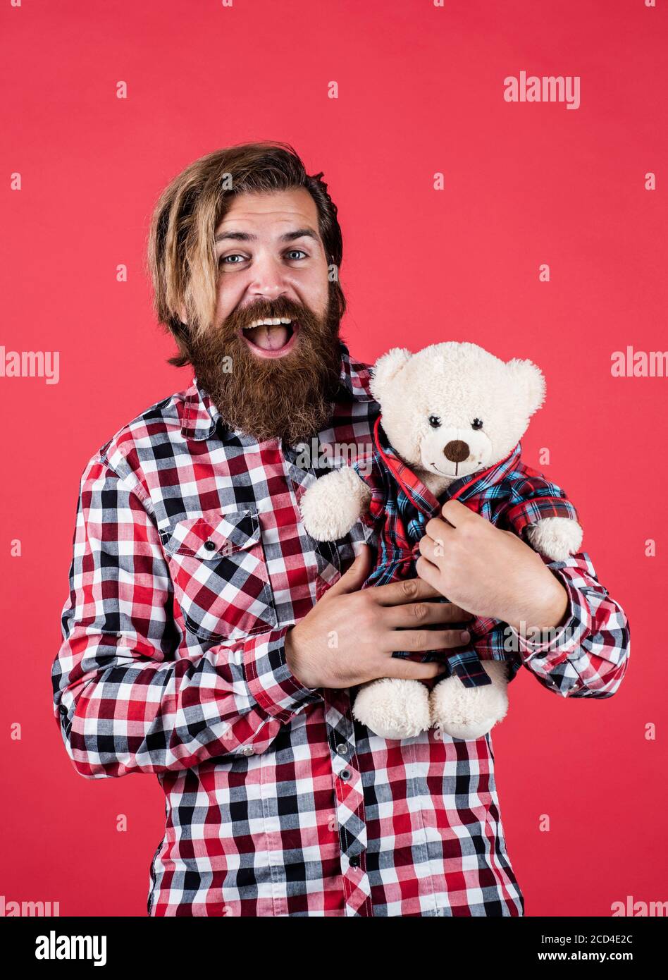 happy valentines day. cheerful bearded man hold teddy bear. male feel playful with bear. brutal mature hipster man play with toy. happy birthday. being in good mood. Stock Photo