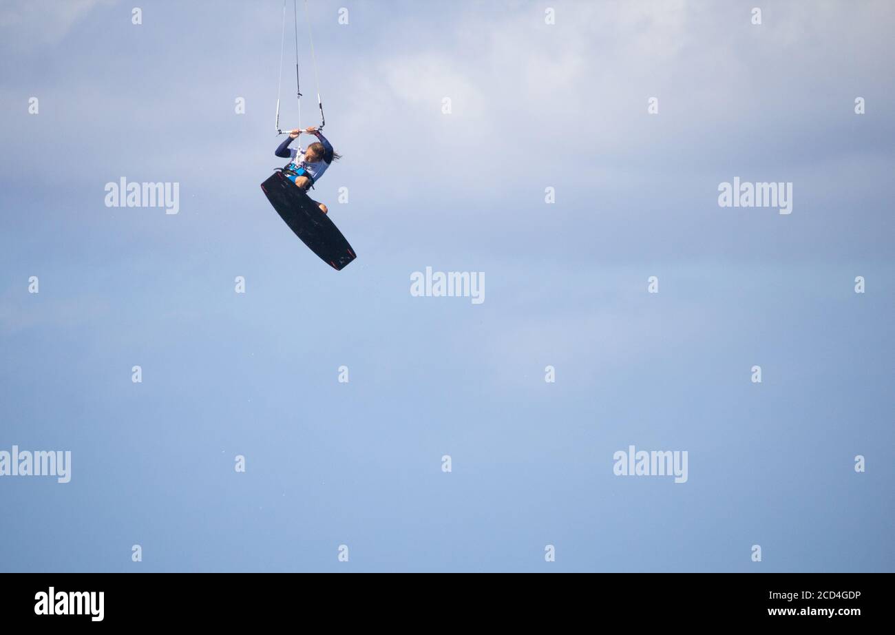 Kitesurfing: Kitesurfer jumping high at Playa de Vargas on Gran Canaria. Stock Photo